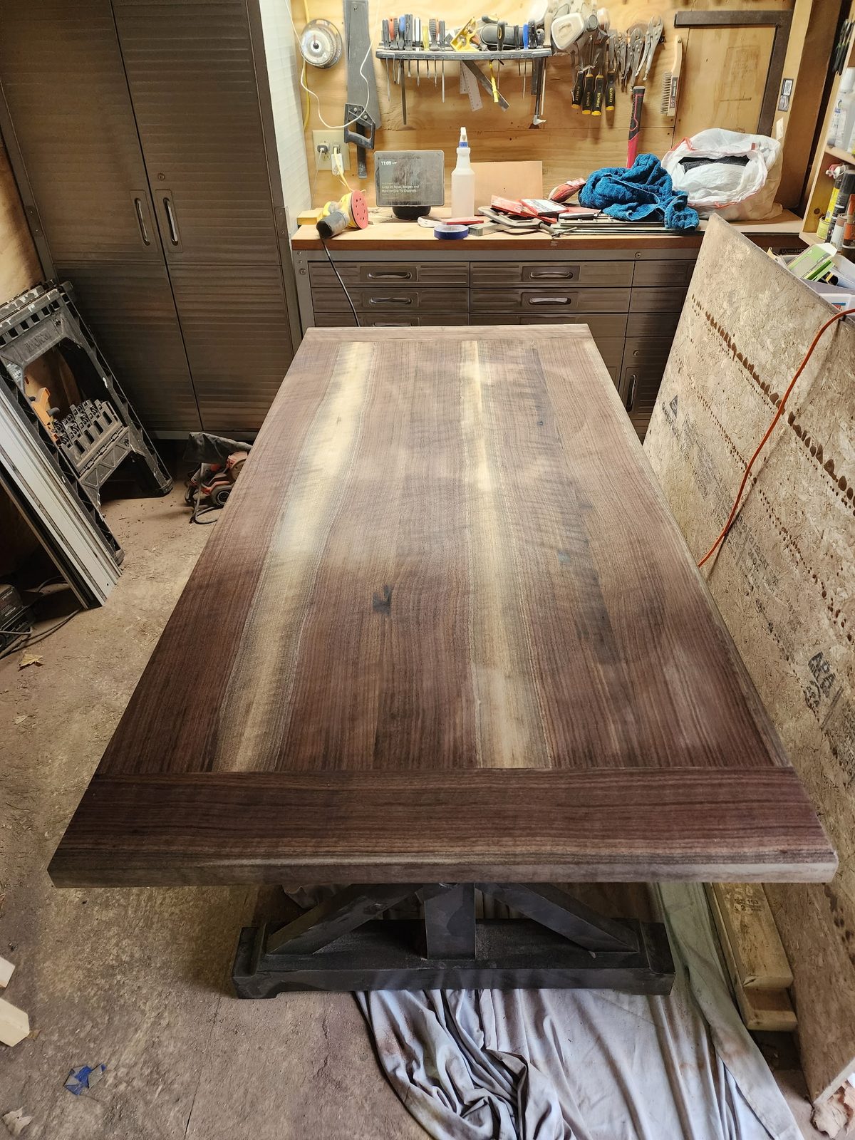 Book-matched walnut tabletop catching shop light